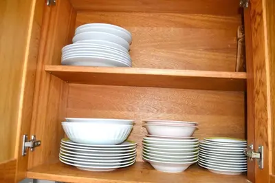 a cabinet with plates and bowls in it at Comfortable Apartment, Torre Alta in San Felipe de Puerto Plata