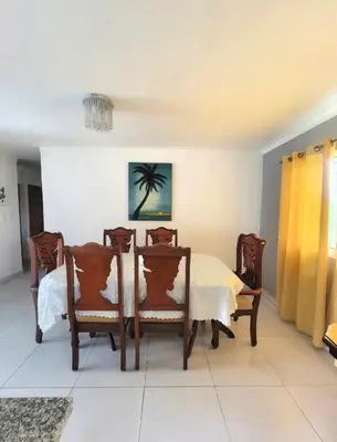 a dining room with a table and chairs at Palma Real Near Cibao Airport in Santiago de los Caballeros