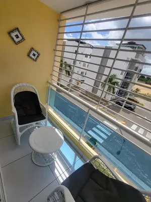 a room with a table and a chair and a window at Palma Real Near Cibao Airport in Santiago de los Caballeros