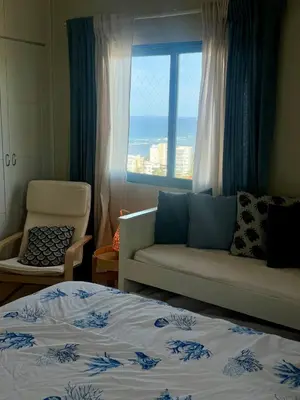 a bedroom with a bed and a couch and a window at JuanDolio Penthouse 3 bedrooms Beachfront frente a hemingway in Los Corrales