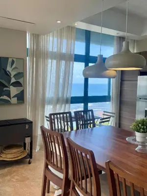 a dining room with a table and chairs with a view at JuanDolio Penthouse 3 bedrooms Beachfront frente a hemingway in Los Corrales