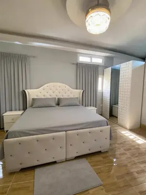 a bedroom with a large white bed in a room at Ameriwest Guest House in Boca Chica