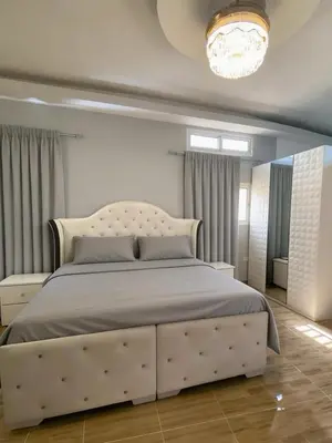 a bedroom with a large bed with a white headboard at Ameriwest Guest House in Boca Chica