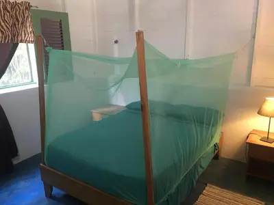 a bed with a canopy in a room at Casa Ylang Ylang, Playa Encuentro in Cabarete