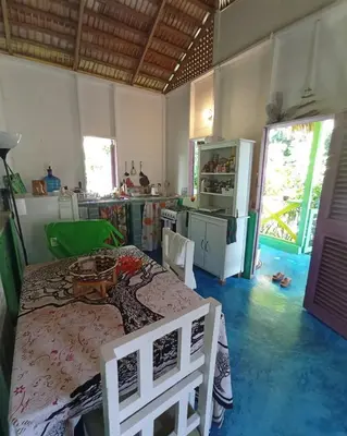 a kitchen with a table and chairs in a room at Casa Ylang Ylang, Playa Encuentro in Cabarete