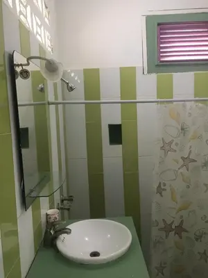a bathroom with a sink and a mirror at Casa Ylang Ylang, Playa Encuentro in Cabarete