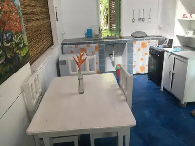 a small kitchen with a table with a vase on it at Casa Ylang Ylang, Playa Encuentro in Cabarete