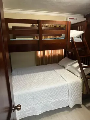 two bunk beds in a room with a white bed at Penthouse in Santo Domingo
