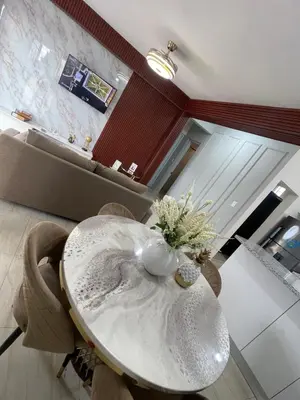 a dining room table with a vase of flowers on it at Apartamento acoger en Santo Domingo este in Hainamosa