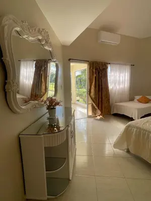 a bedroom with a mirror on the wall and a bed at 360 View House with Private Pool Jacuzzi and Terrace in Puerto Plata