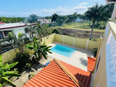 a view of a swimming pool from a house at 360 View House with Private Pool Jacuzzi and Terrace in Puerto Plata