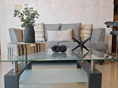 a living room with a couch and a glass table at 3 Bed, 2 Bath, Hot Water, Apartment near the beach, in Bani in Baní