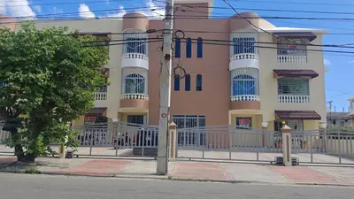 a pink and white building with a fence in front of it at 3 Bed, 2 Bath, Hot Water, Apartment near the beach, in Bani in Baní