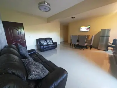 a living room with a couch and a dining room at Cozy apartment, AC, Wifi, 2BR, 2Bath, Bani, 1-B in Baní