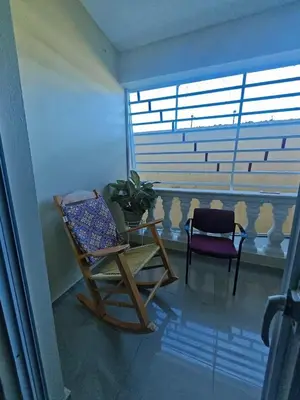 a room with a rocking chair and a window at Cozy apartment, AC, Wifi, 2BR, 2Bath, Bani, 1-B in Baní