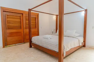 a bedroom with a four poster bed and a closet at Las Marinas Los Nmada, 80 meters from Coson beach in Las Terrenas