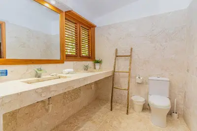 a bathroom with a sink and a toilet and a mirror at Las Marinas Los Nmada, 80 meters from Coson beach in Las Terrenas