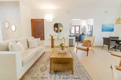 a living room with a white couch and a table at Tropical Villa in Playa Bonita in Pasos Del Mar in Las Terrenas