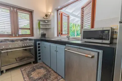 a kitchen with a microwave oven and a sink at Tropical Villa in Playa Bonita in Pasos Del Mar in Las Terrenas