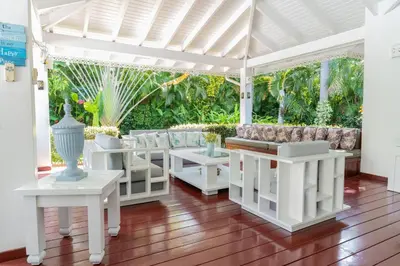 a white pergola with white tables and couches at Tropical Villa in Playa Bonita in Pasos Del Mar in Las Terrenas