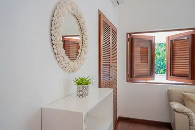 a living room with a mirror and a white table at Tropical Villa in Playa Bonita in Pasos Del Mar in Las Terrenas