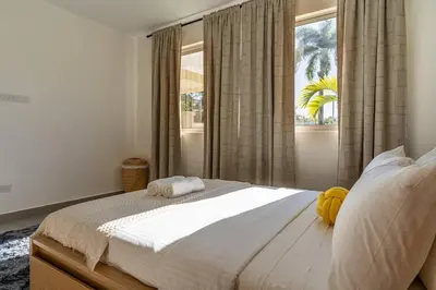 a bedroom with a large bed and a window at Caribey 200 meters from Punta Popy beach in Las Terrenas