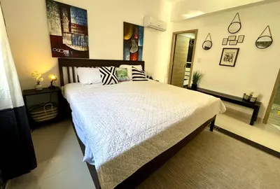a bedroom with a large bed in a room at Modern Central Ocean View and Jacuzzi Apartment in Santo Domingo