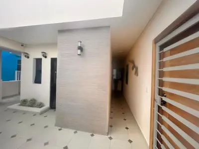 a hallway with a pivot door in a house at El descanso in Mata Chalupe