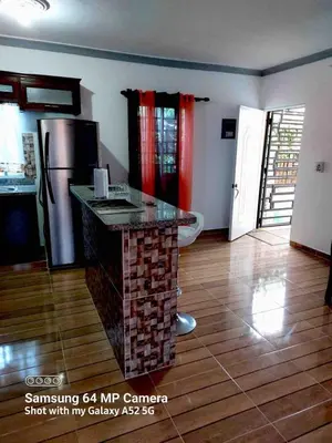 a kitchen with a island in the middle of a room at Stylish Apartment Steps from Puerto Plata Malecon in San Felipe de Puerto Plata