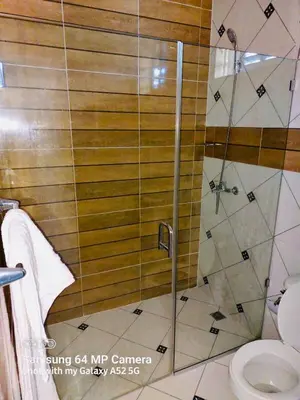 a bathroom with a shower and a toilet at Stylish Apartment Steps from Puerto Plata Malecon in San Felipe de Puerto Plata