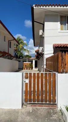 a wooden gate in front of a white house at Casa Mattia in La Laguna