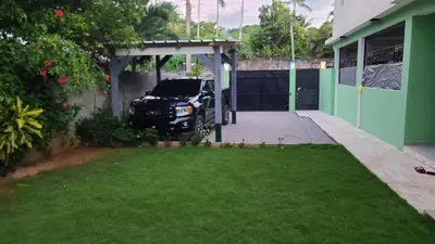 a car parked under a garage in a driveway at Casa Brisa del Río in Las Terrenas