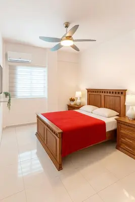 a bedroom with a bed and a ceiling fan at Boca chica playa y sol in Boca Chica