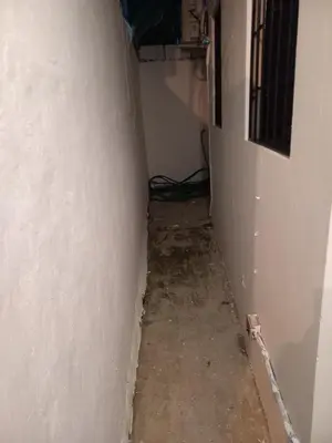 an empty hallway with a white wall and a floor at Casa Petter og Maria first floor in Santiago de los Caballeros
