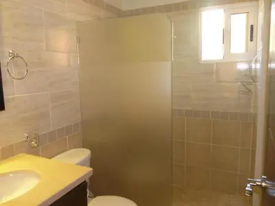 a bathroom with a shower and a toilet and a sink at Villa near the beach in Cabarete