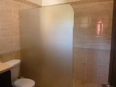 a bathroom with a toilet and a shower stall at Villa near the beach in Cabarete