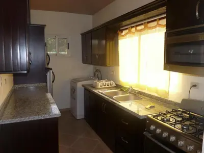 a kitchen with a sink and a stove top oven at Villa near the beach in Cabarete
