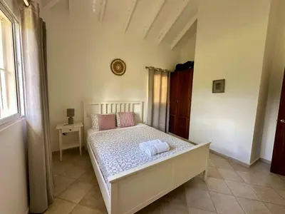 a bedroom with a bed with two pillows on it at Casa Siete Las Terrenas in Las Terrenas
