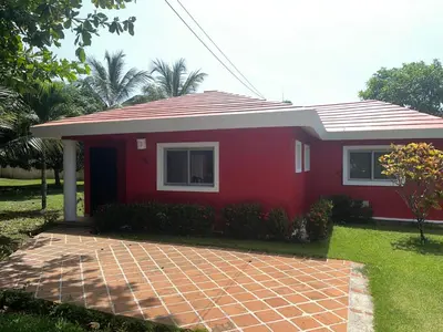 a red house with a brick driveway in front of it at Villa amalu in Cabarete