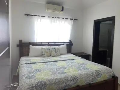 a bedroom with a large bed with a window at Villa amalu in Cabarete