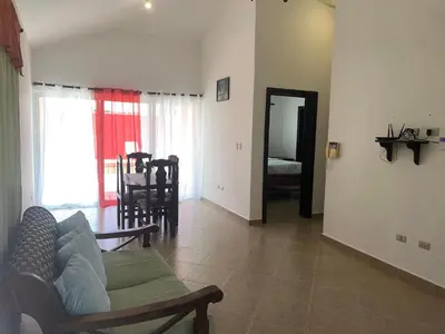 a living room with a couch and a table at Villa amalu in Cabarete