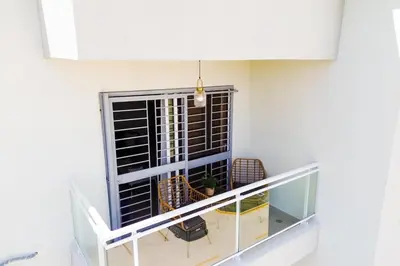 a balcony with a window with a table and chairs at vacation apartment BANI PERAVIA in Boca Canasta