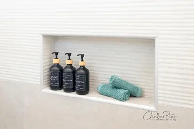 a shelf with four bottles of wine and a towel at Estrella Garden Shaula 301 New Modern Penthouse in La Laguna