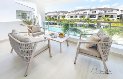 a balcony with a table and chairs and a view of a pool at Estrella Garden Shaula 301 New Modern Penthouse in La Laguna