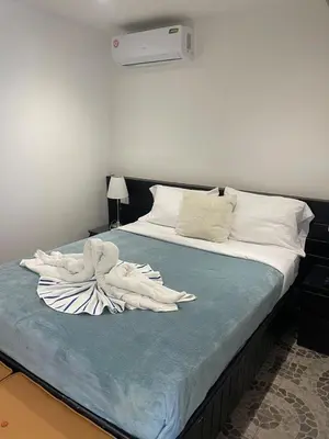 a bed with two towels on top of it at Villa Mirna in Las Terrenas