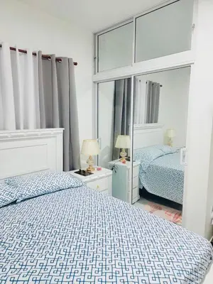 a bedroom with two beds and a large mirror at Comfortable and warm apartment in Higuey