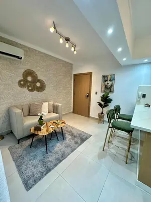 a living room with a couch and a table at Moderno 1 Habitación Cerca Avenida Churchill in Santo Domingo