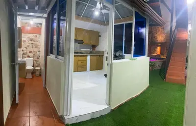 an open door to a kitchen with green grass at Constanza Family House in Constanza