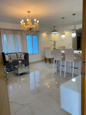 a living room with a table and chairs and a chandelier at A space designed for you in San Cristóbal