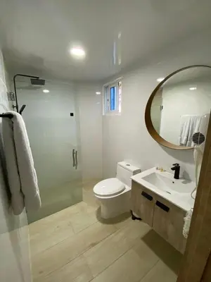 a bathroom with a toilet and a sink and a mirror at A space designed for you in San Cristóbal